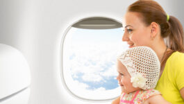 Airplane flight from inside. Woman and kid travelling together.