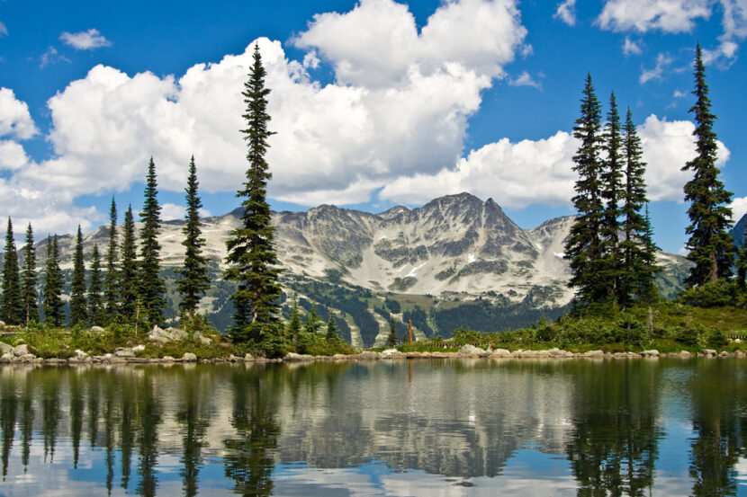 Mountain peaks reflecting off the water in nearby pond