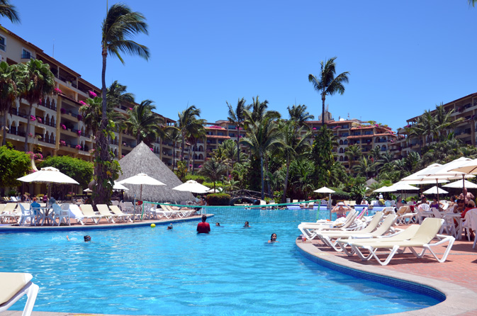 Guests swim or enjoy a game of water volleyball in the pool