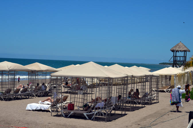 Guests chill out in beach cabanas