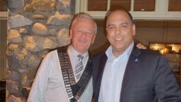 Skål International Vancouver President Greg Moon (left) greets new member Michael Favelle.