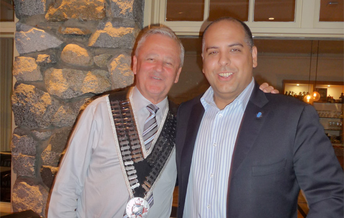 Skål International Vancouver President Greg Moon (left) greets new member Michael Favelle.
