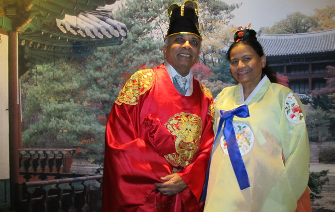 Travel agents Kokila Patel of Quick Travels and Pravin Patel of Durrani Travels try on traditional Korean attire.