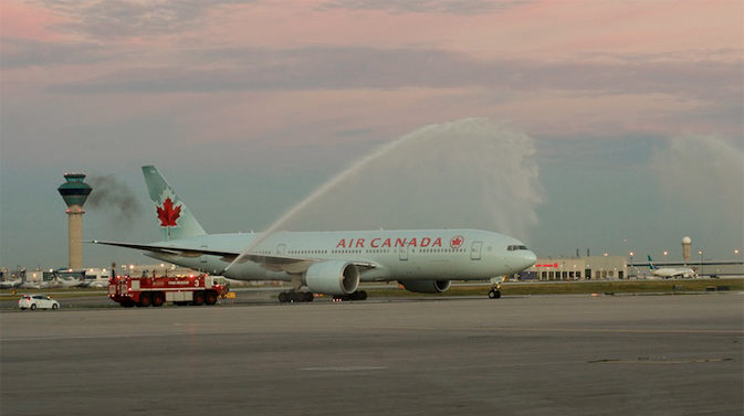Returning Olympic athletes get a water cannon salute