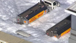 Bobbing white foam engulfs hangar and streets at San Jose aiport