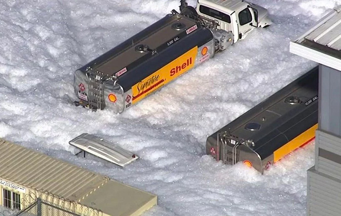 Bobbing white foam engulfs hangar and streets at San Jose aiport