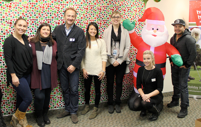 Trafalgar team celebrates the season with Holiday Helpers wrap-a-thon