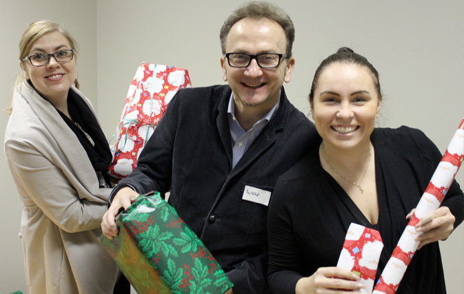 Trafalgar team celebrates the season with Holiday Helpers wrap-a-thon
