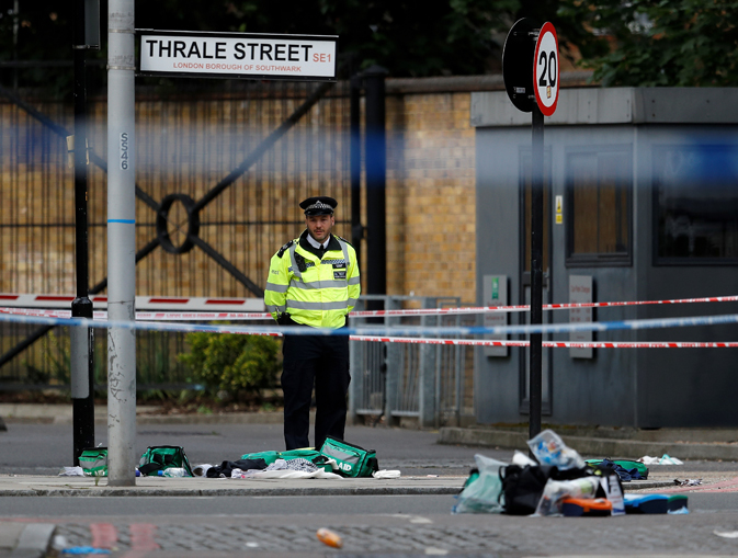 A police officer stands behind discarded medical equipment near Borough Market. REUTERS/Peter Nicholls