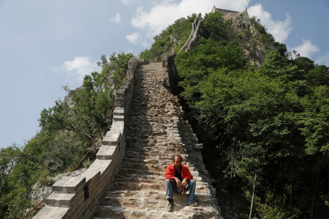 A man rests while working on the reconstruction of the Jiankou section of the Great Wall, located in Huairou District, north of Beijing, China, June 7, 2017. REUTERS/Damir Sagolj