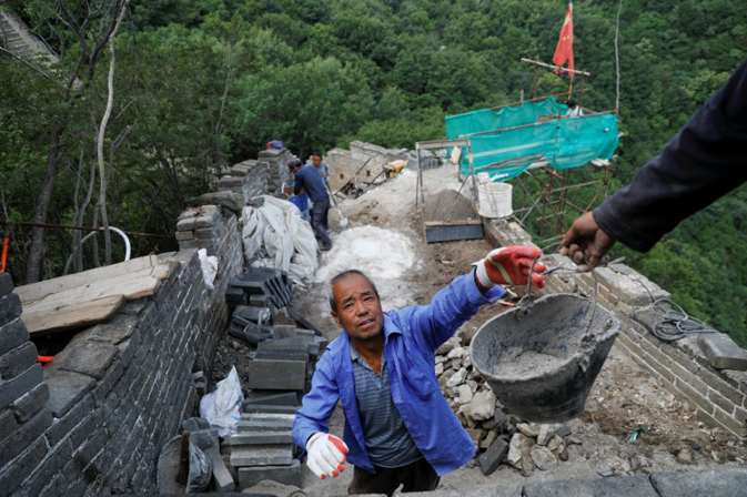 People work on the reconstruction of the Jiankou section of the Great Wall, located in Huairou District, north of Beijing, China, June 7, 2017. REUTERS/Damir Sagolj