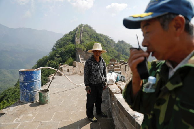 People pause from working on the reconstruction of the Jiankou section of the Great Wall, located in Huairou District, north of Beijing, China, June 7, 2017. REUTERS/Damir Sagolj