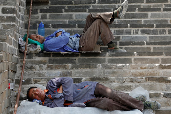 People rest after working on the reconstruction of the Jiankou section of the Great Wall, located in Huairou District, north of Beijing, China, June 7, 2017. REUTERS/Damir Sagolj