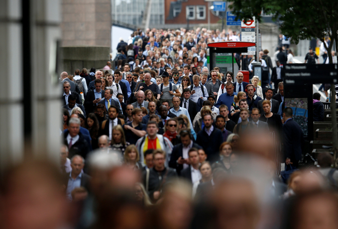 Commuters walk accross London Bridge after is was reopened