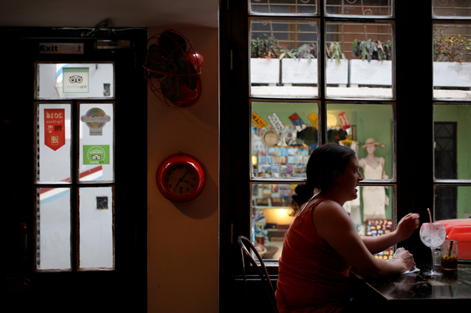 A woman has a drink in a bar in Havana, Cuba June 12, 2017. REUTERS/Stringer