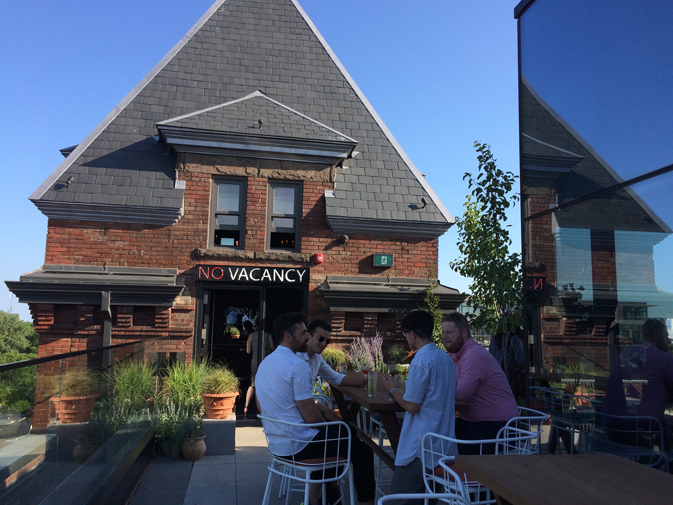 Rooftop drinks next to the 'No Vacancy' sign, where guests will find a private rooftop dining space