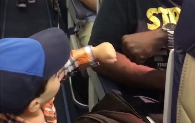This two-year-old fist bumped everyone on his flight, prompting hearts to melt around the world