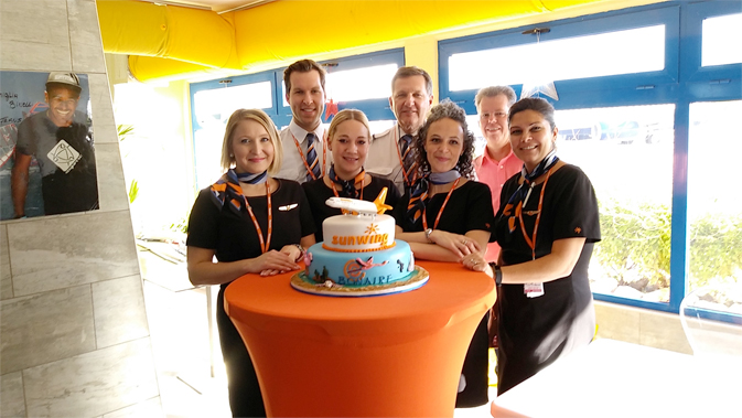The Sunwing cabin crew and pilot Captain Chris Lewis celebrated the inaugural flight from Toronto with Bonaire Tourism Board by cutting into a welcome cake. Photo credit: First Officer James Parsons