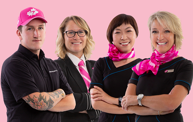 WestJet Breast Cancer Awareness Month Ambassadors Rudy, Carey, Cat, and Lynn in their custom-designed pink-neckwear, hat and pink ‘personality’ pins