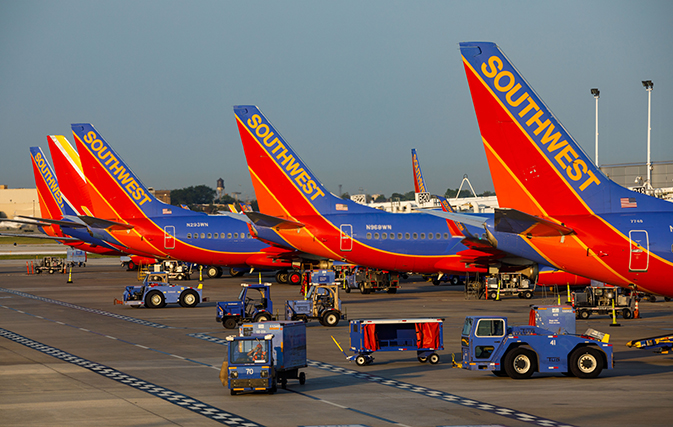 Watch this baggage handler do a fist pump while tossing luggage