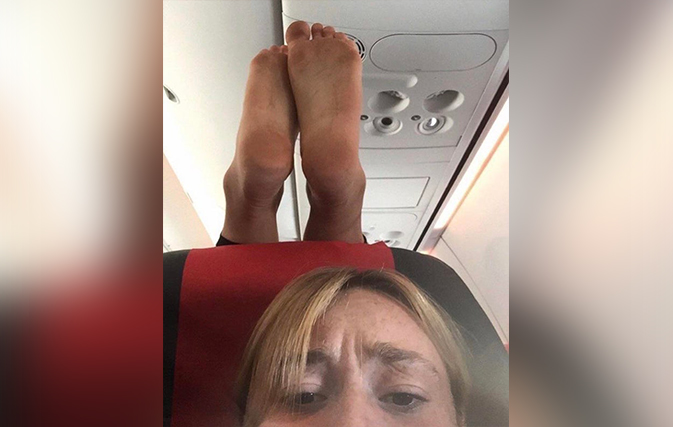 What-would-you-do-question-mark-Passenger-snaps-pic-of-dirty-feet-dangling-above-her-head